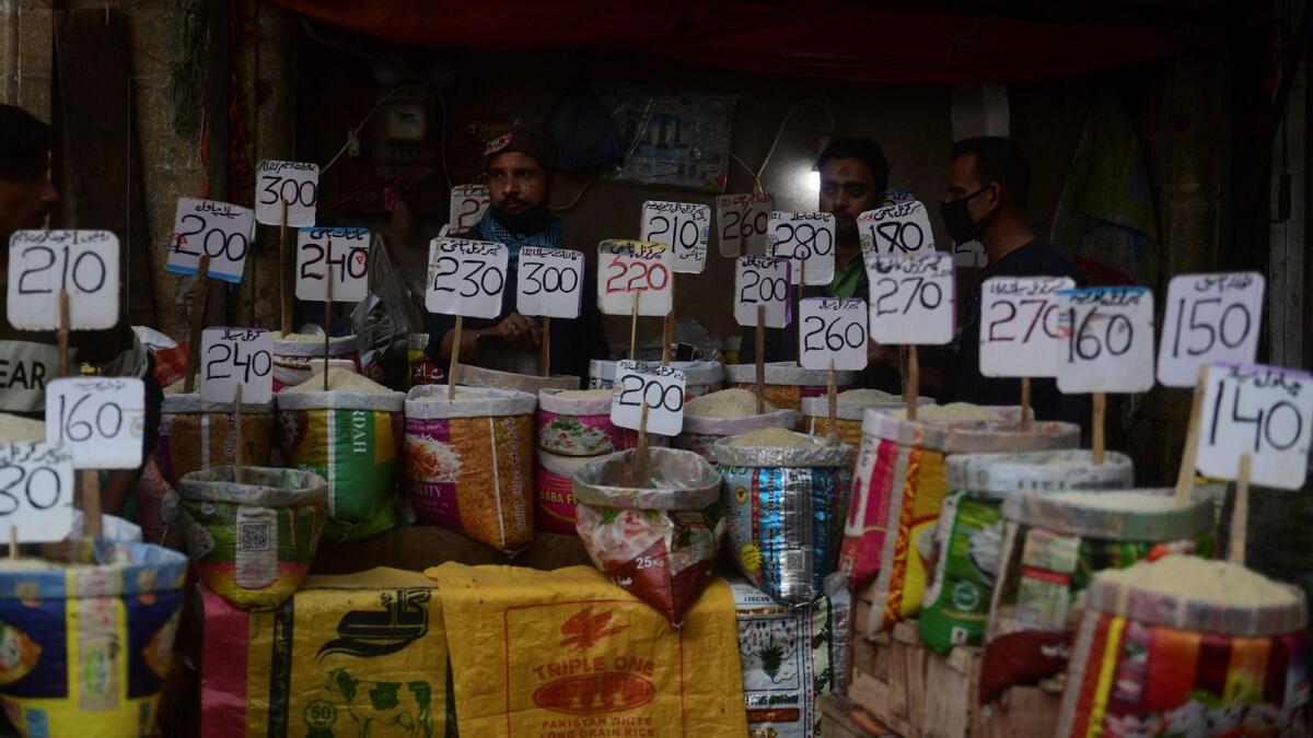 Shopkeepers display prices rate of rice at a wholesale market in Karachi. The country is undertaking key measures to secure the IMF funding, including raising taxes, removing blanket subsidies, and artificial curbs on the exchange rate.-  AFP
