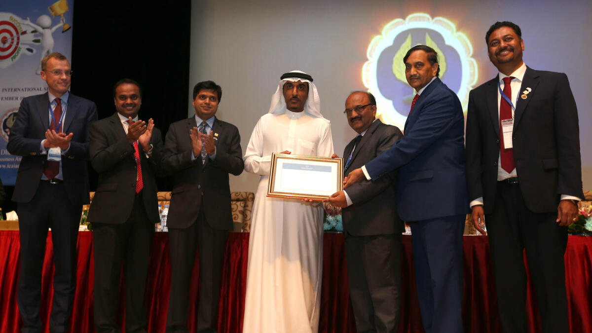 Manoj Fadnis receiving the certificate of incorporation from Dhaher bin Dhaher Aimheiri at the ICAI’s 27th Annual International Seminar in Abu Dhabi. They were joined by Martin Tidestrom, Summer Seth, Rajiv Shah, Ganpat Singhvi and Padmanabha Acharya. — Photos by Ryan Lim