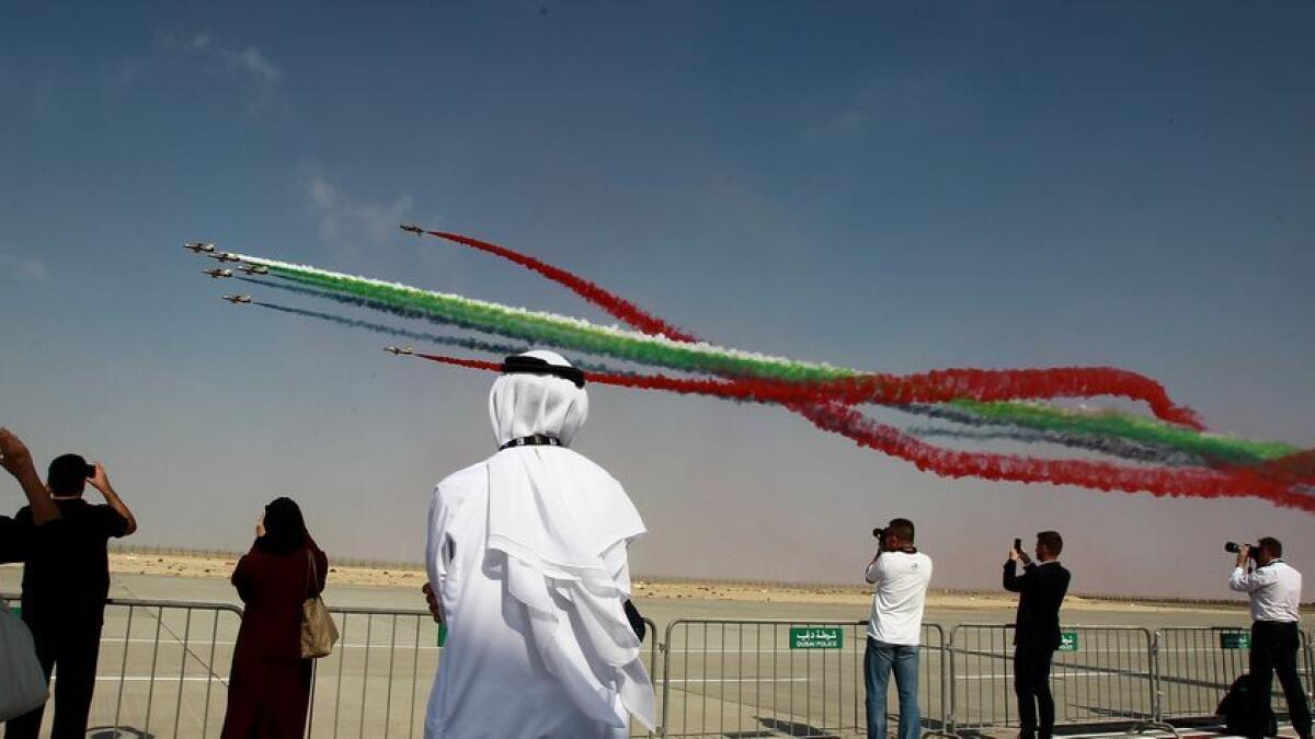 Crowds watch the colorful display of Al Fursan during the Dubai Air Show. -Photo by Shihab/Khaleej Times