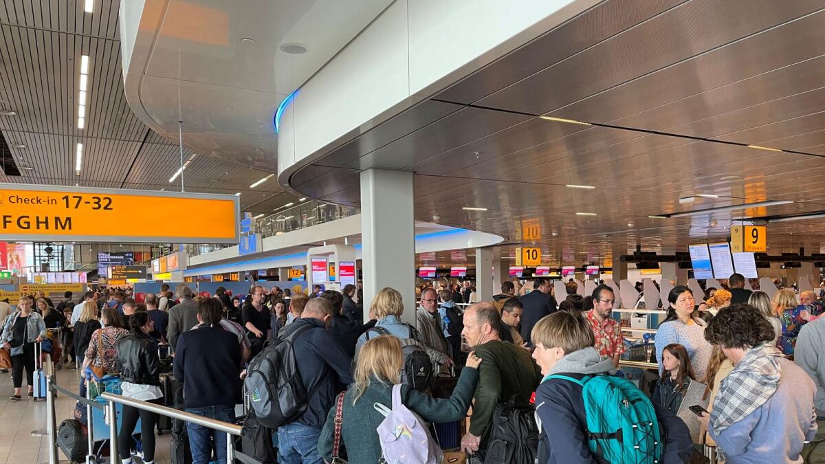 Travellers wait in lines at Amsterdam Schiphol Airport. Airports, airlines and government agencies have been staffing up to avoid crippling labour shortages. - Reuters file