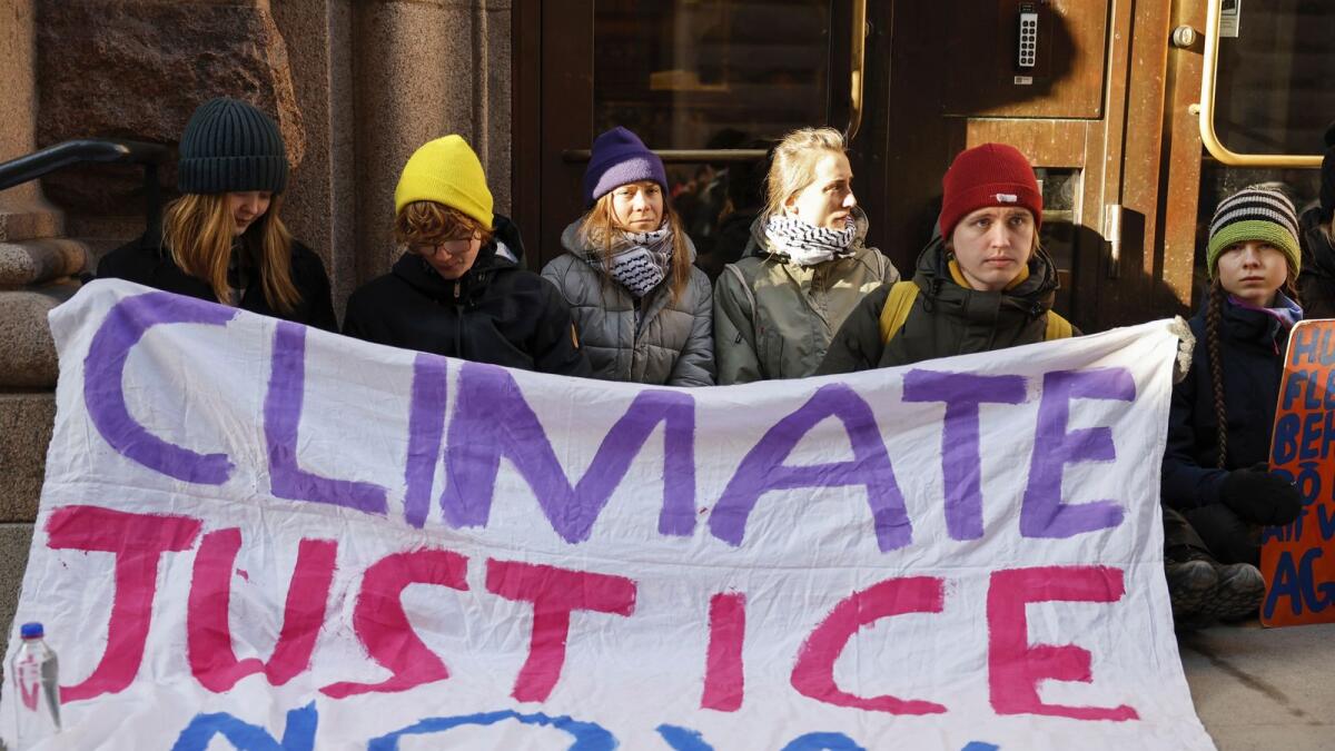 Greta Thunberg and other protesters block the entrance of the Swedish Parliament during a climate protest in Stockholm. — AP
