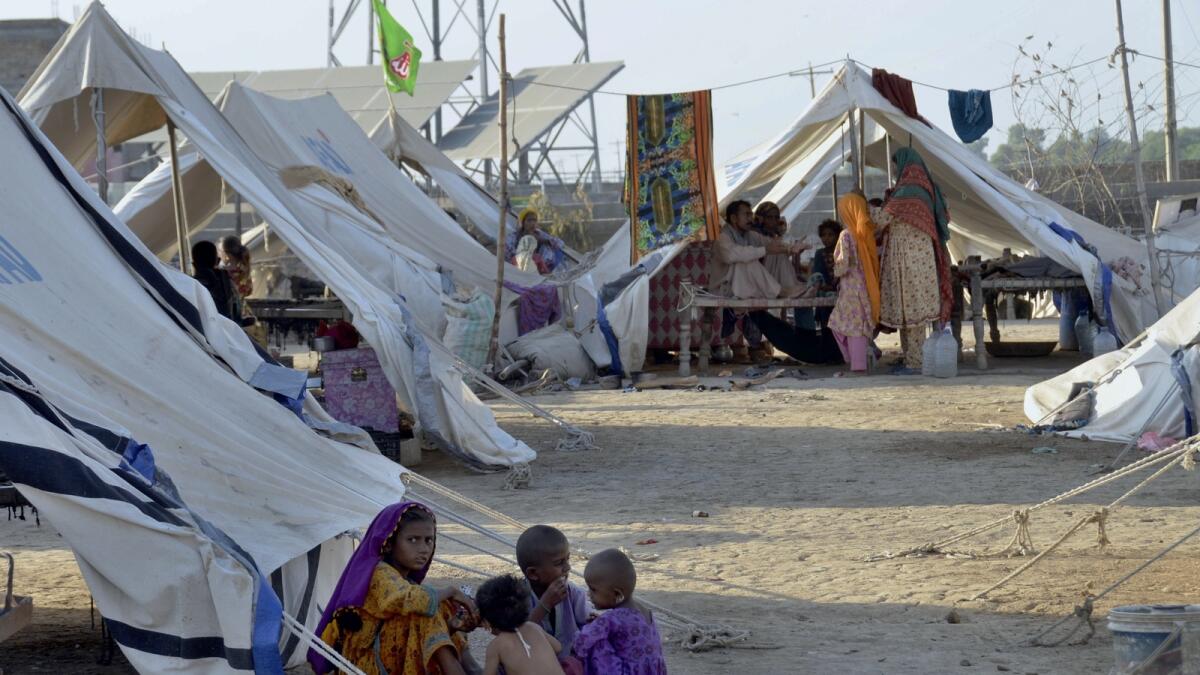 Children play outside their tent at a relief camp, in Jaffarabad, a district in the southwestern Balochistan province. — AP