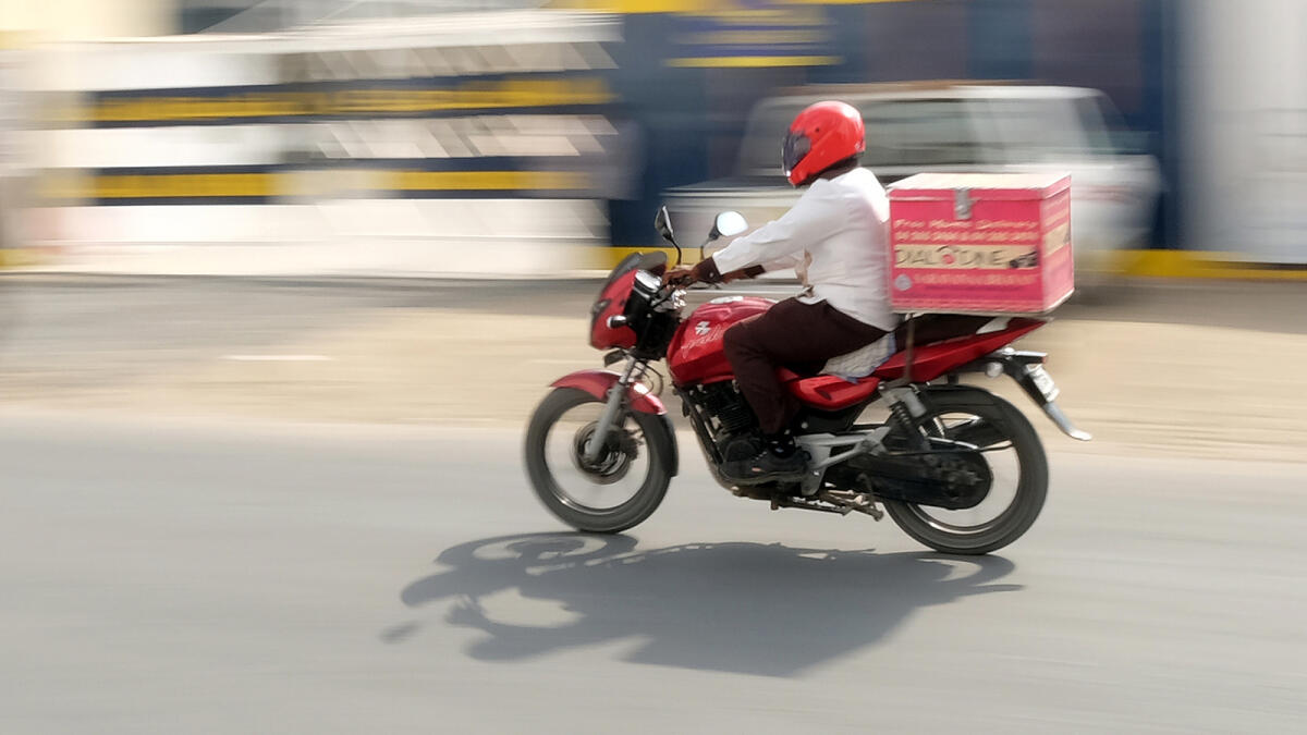 NA130116-SK-FOOD DELIVERYRestaurant delivery boy on the way to deliver parcel food from a restaurant  at Dubai. 13 January,2016. Photo by Shihab
