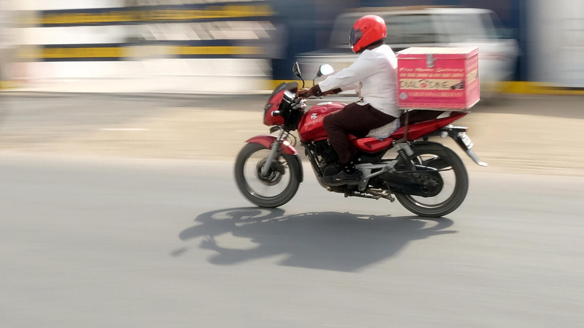 NA130116-SK-FOOD DELIVERYRestaurant delivery boy on the way to deliver parcel food from a restaurant  at Dubai. 13 January,2016. Photo by Shihab