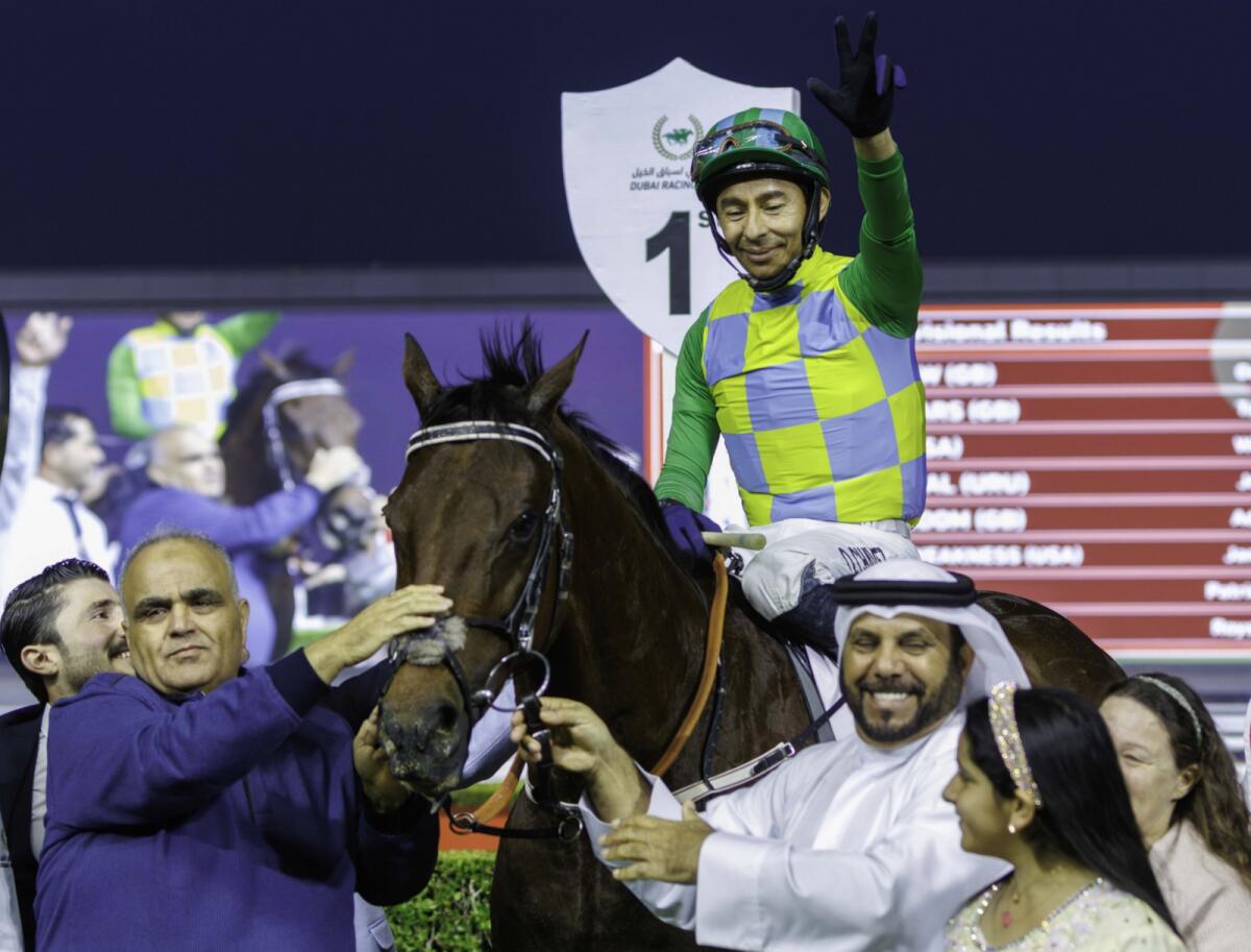 Emirati trainer Musabbeh Al Mheiri celebrates in the winner's enclosure after Military Law earned an invitation to the Dubai World Cup. — Dubai Racing Club