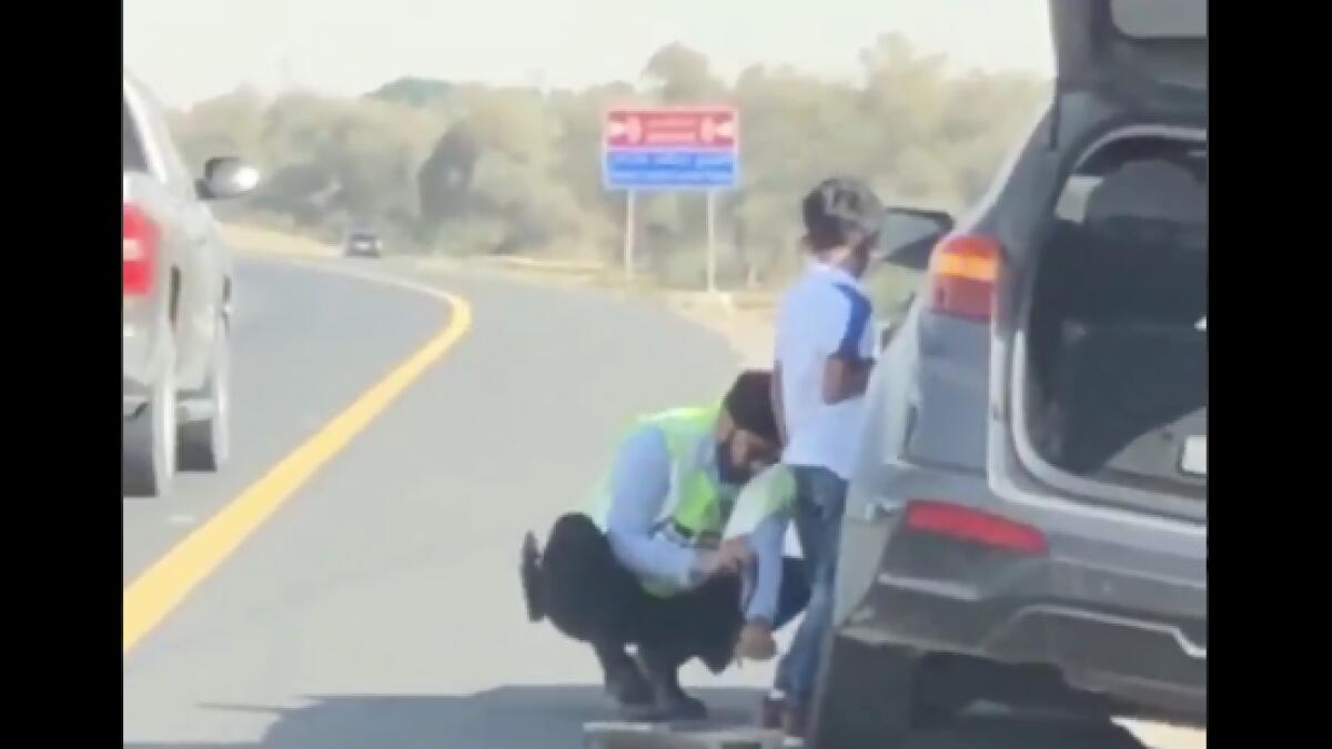 Video: UAE police officer goes viral for changing tyre of stranded SUV 