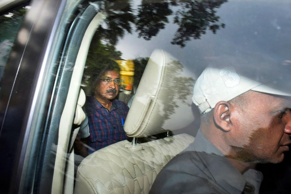 Arvind Kejriwal leaves in a car after a court extended his custody  in New Delhi on Thursday. — AP