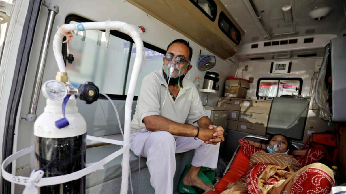 Patients with a breathing problem wait inside an ambulance to enter a Covid-19 hospital for treatment in Ahmedabad. — Reuters
