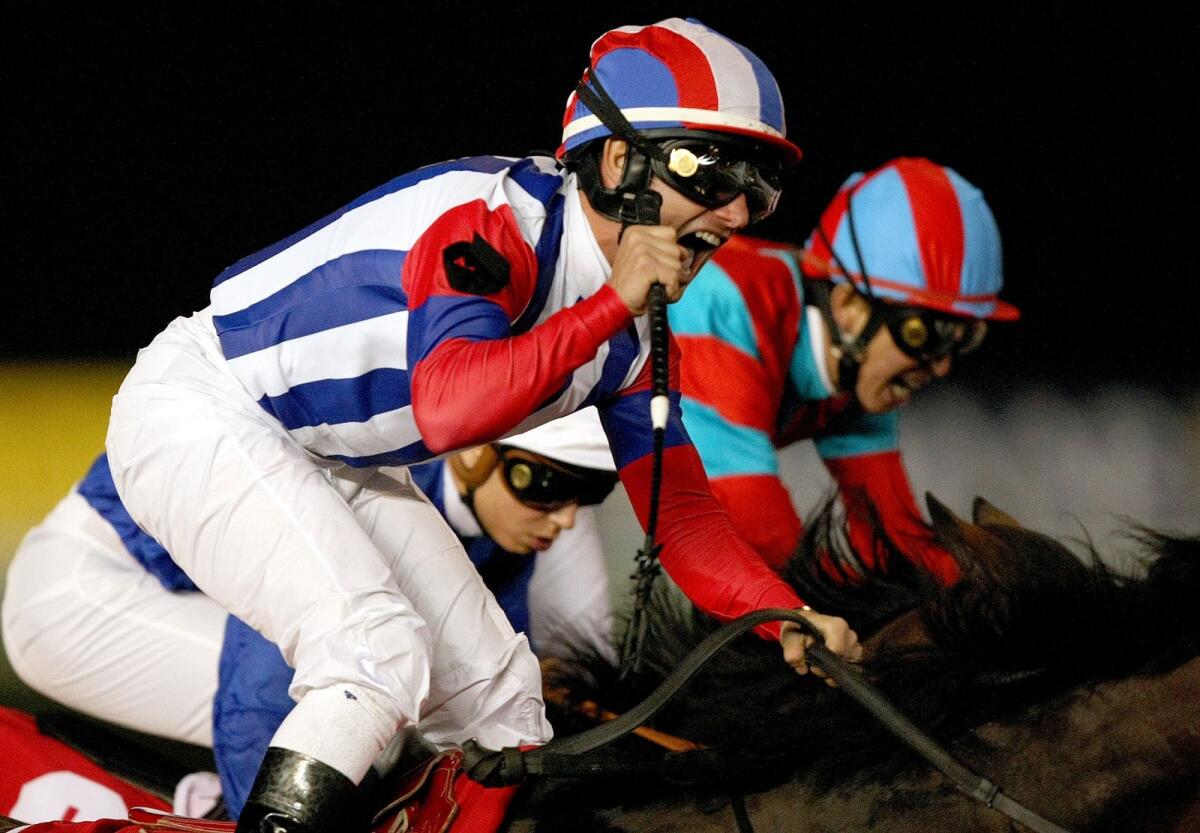 Jockey Micro Demuro celebrates after leading Japanese horse Victoire Pisa to victory  in the 2011 Dubai World Cup. — AFP file
