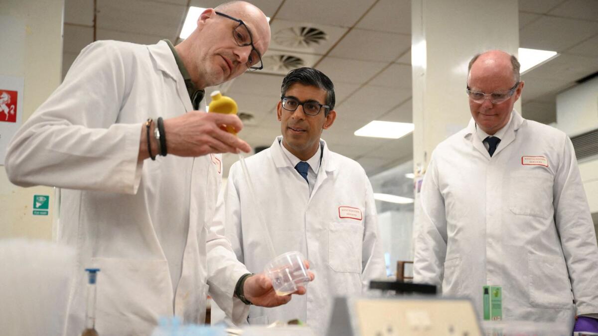 Britain's Prime Minister Rishi Sunak and Chief Medical Officer Professor Sir Chris Whitty visit a lab testing vaping products at Kent Scientific Services in West Malling, Kent, Britain, on Tuesday. — Reuters