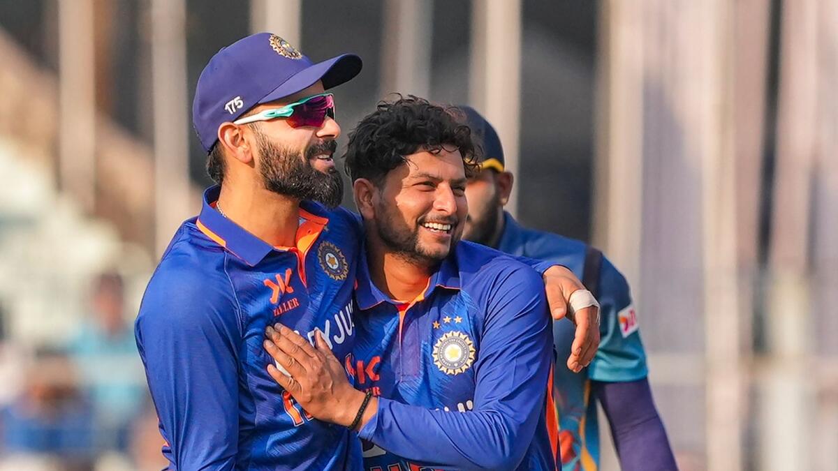Indian bowler Kuldeep Yadav celebrates with teammate Virat Kohli after taking the wicket of Sri Lankan batter Charith Asalanka. — PTI