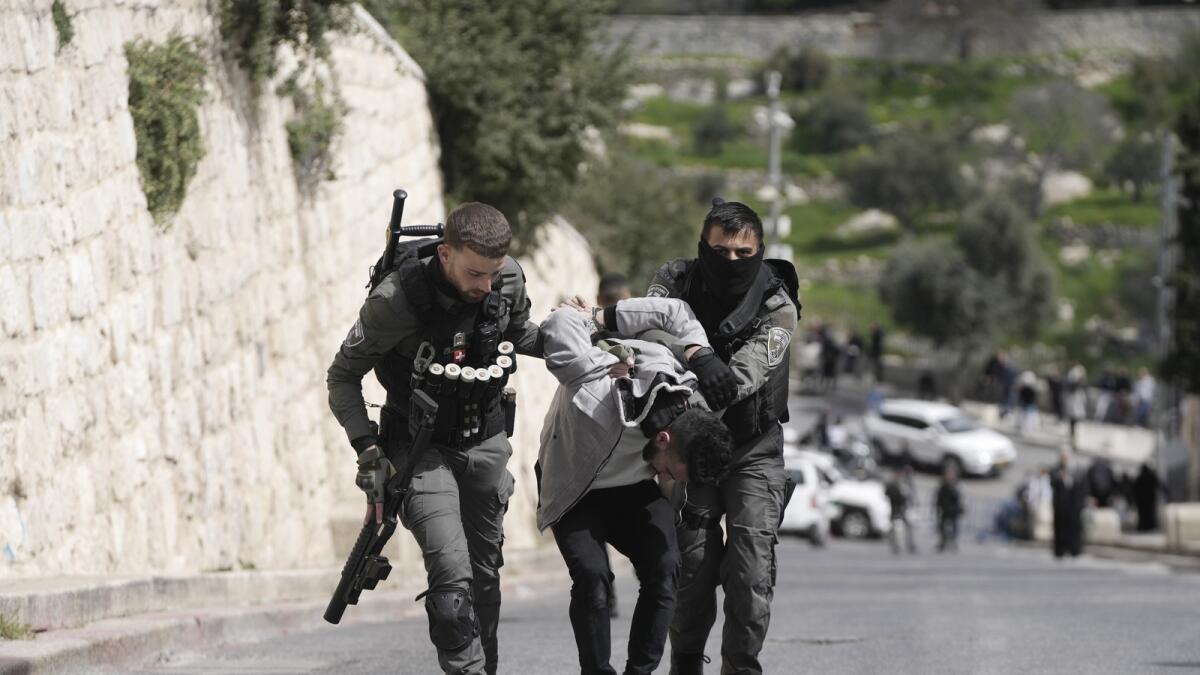 Israeli Border Police detain a Palestinian man ahead of Friday prayers at the Al Aqsa Mosque compound in the Old City of Jerusalem. — AP