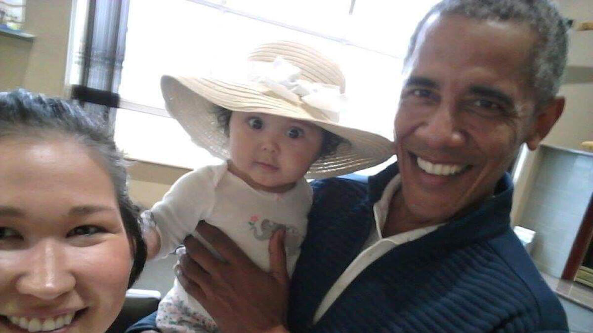 Mom, child take a selfie with Barack Obama
