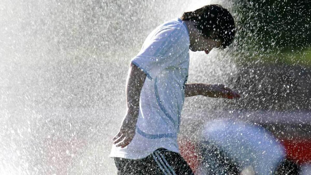 Lionel Messi gets a surprise soaking by a sprinkler during an Argentina training session during the 2006 World Cup in Germany.