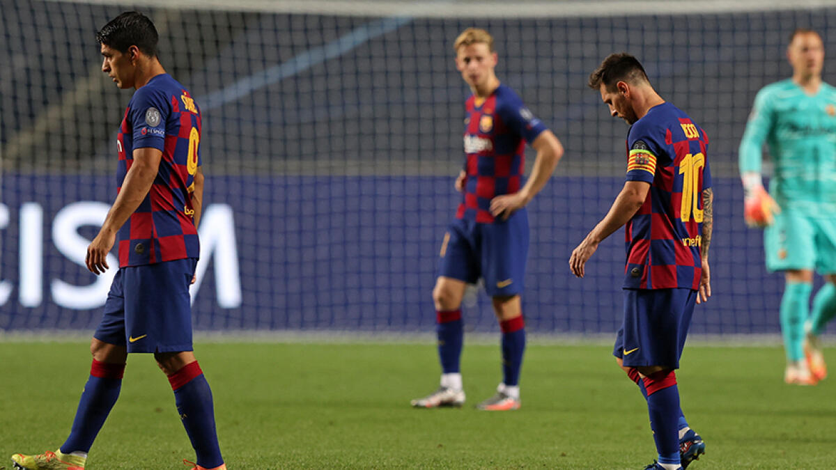 Barcelona's Lionel Messi (right) and Luis Suarez (left) react during their 8-2 rout against Bayern Munich. -- AFP