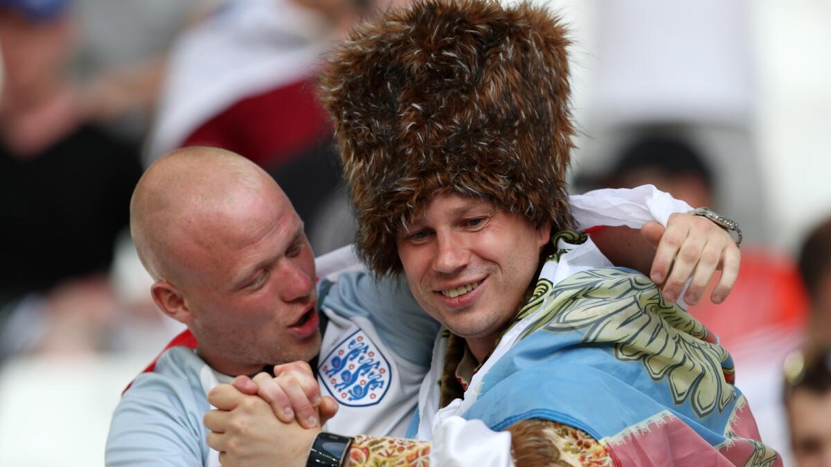 Fans of England and Russia joke each other before the Euro 2016 Group B soccer match between England and Russia, at the Velodrome stadium in Marseille, France, Saturday, June 11, 2016.