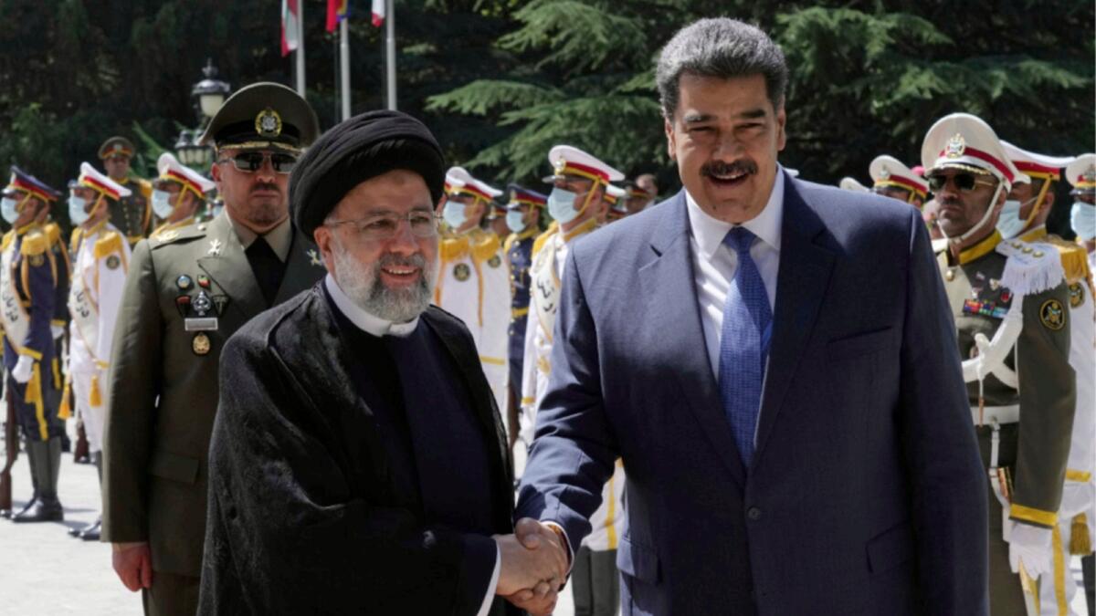 Venezuela's President Nicolas Maduro, right, is welcomed by his Iranian counterpart Ebrahim Raisi during his official welcoming ceremony at the Saadabad Palace in Tehran. — AP