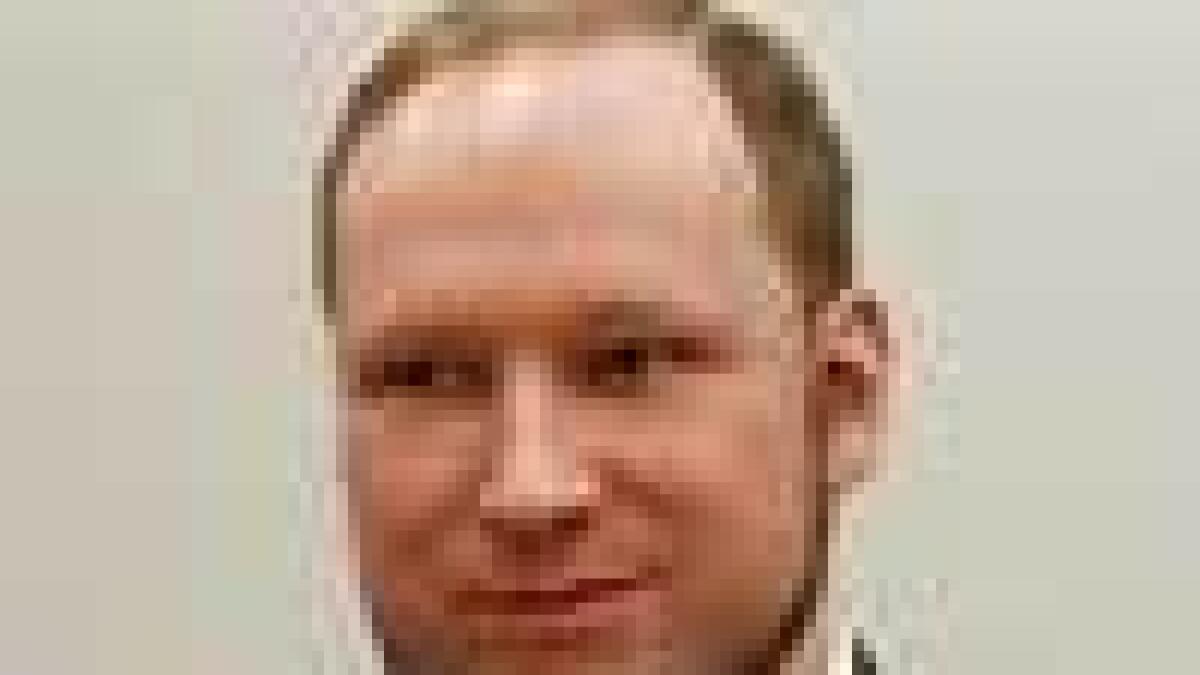 Breivik smiles smugly as he is sent to prison