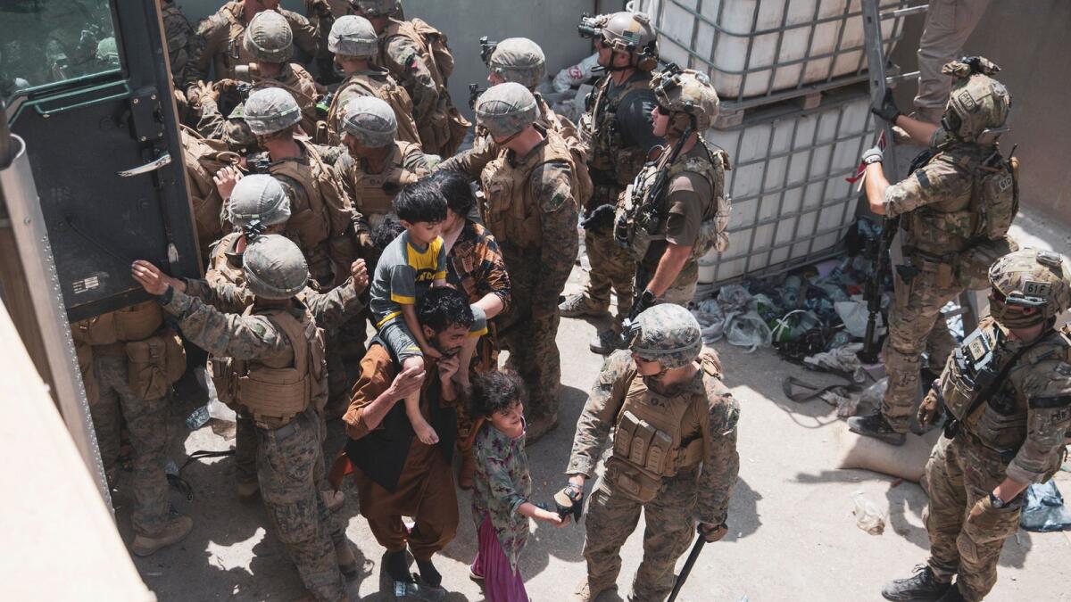 U.S. Marines and Norwegian coalition forces assist with security at an Evacuation Control Checkpoint at Hamid Karzai International Airport, Kabul. Photo: Reuters