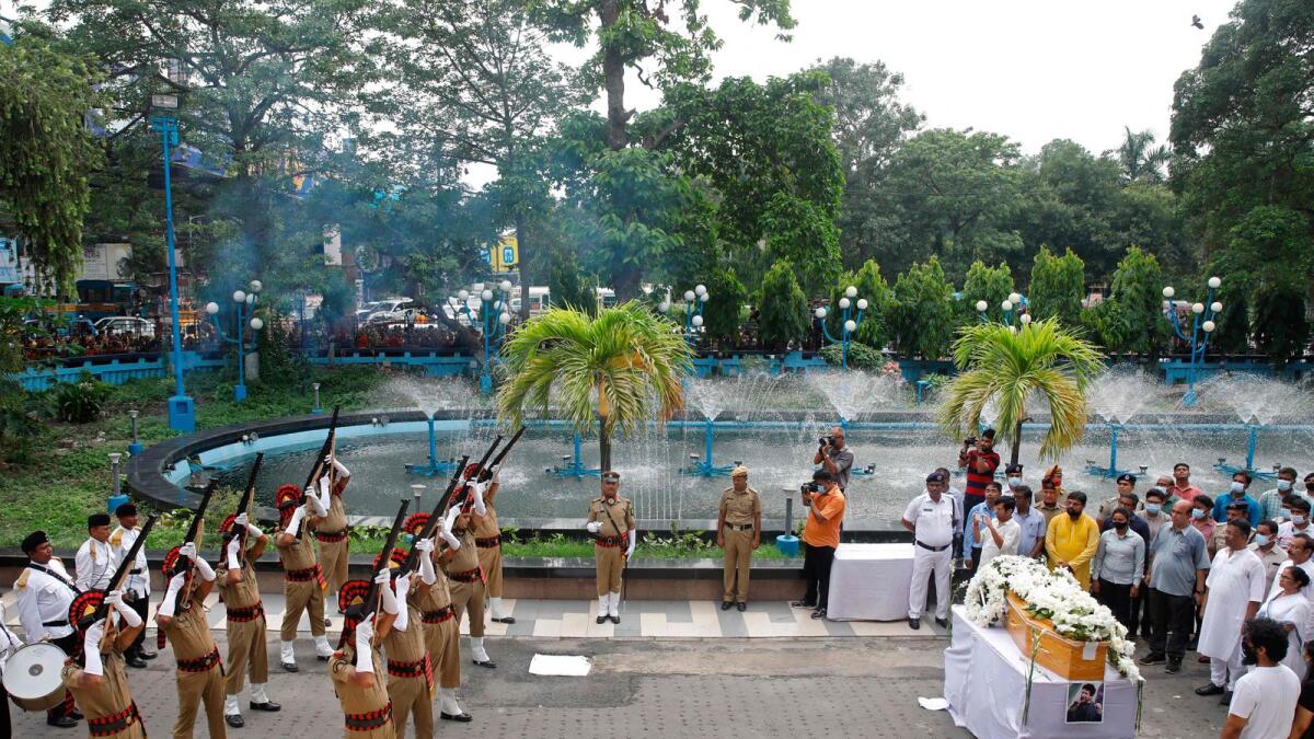 Policemen give a gun salute next to the coffin of late Bollywood singer Krishnakumar Kunnath, popularly known as KK, in Kolkata on June 1. (Photo: AFP)