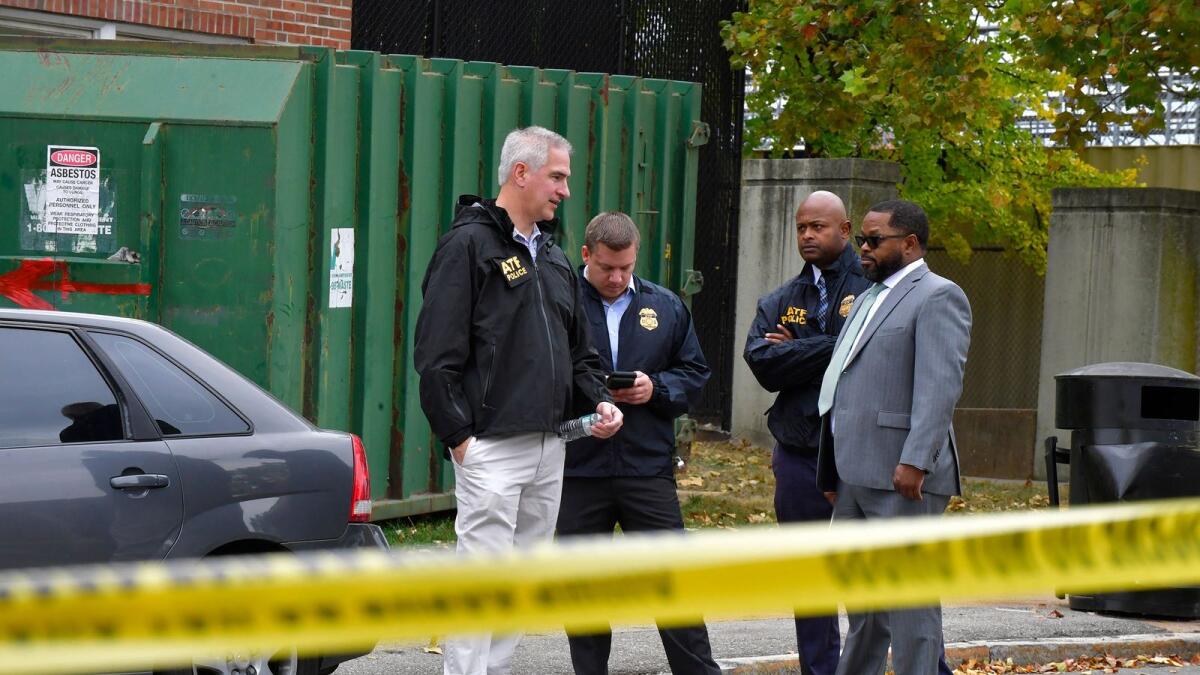 US officials stand outside the north side of the Central Visual and Performing Arts High School after a shooting that left three people dead including the shooter in St Louis. — AFP