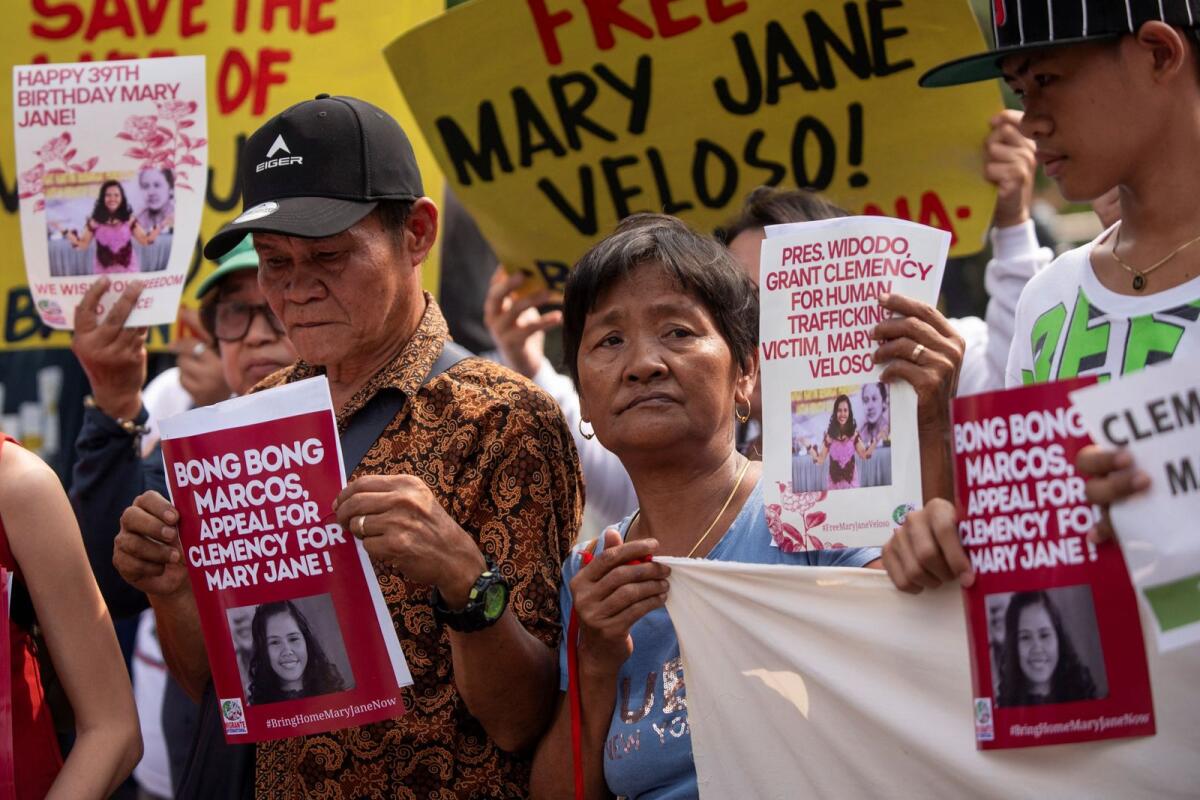 Relatives and supporters of Mary Jane Veloso, a Filipina on death row after being convicted in Indonesia for drug smuggling, hold a protest in time with Indonesia President Joko Widodo's visit in Manil on Tuesday.  — Reuters