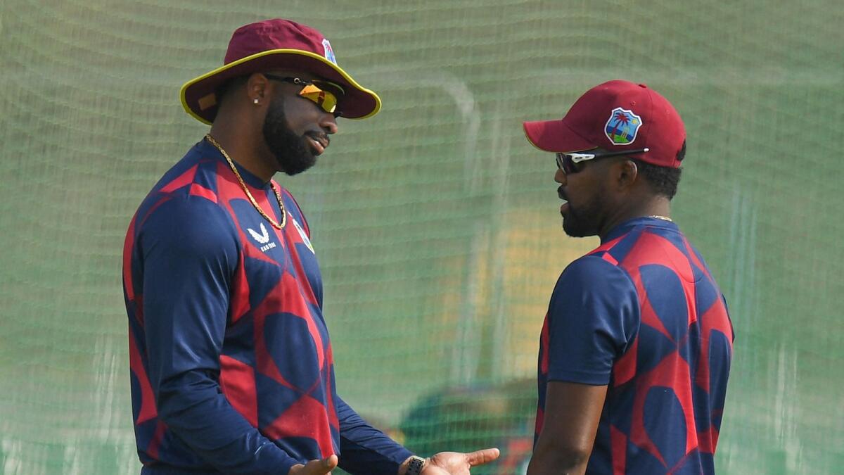 West Indies' Kieron Pollard (left) with teammate Obed McCoy during a practice session at the Sheikh Zayed Cricket Stadium in Abu Dhabi on Monday. (AFP)