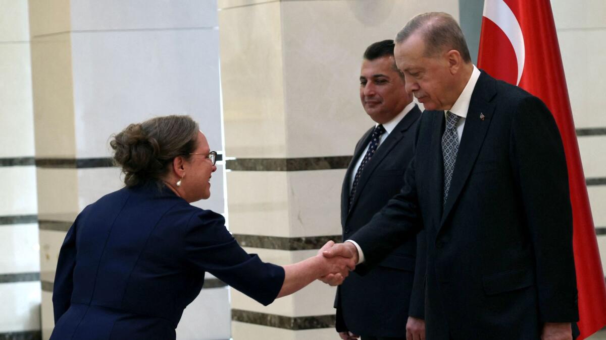 Turkish President Recep Tayyip Erdogan (R) shakes hands with Israel's Ambassador to Ankara Irit Lillian (L) as he receives the letter of credence, at the Presidential Complex in Ankara on Tuesday. — AFP