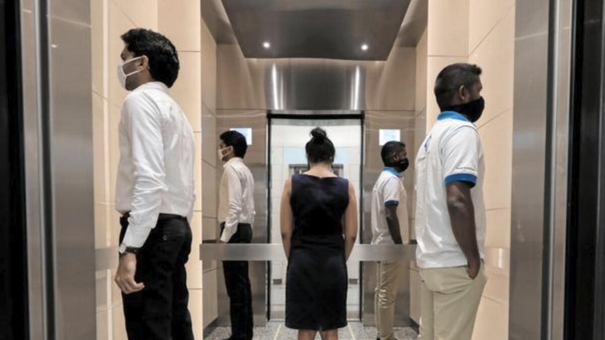 People practice social distancing inside an elevator prior to arriving to their workplaces at World Trade Center, in Colombo, Sri Lanka. Reuters