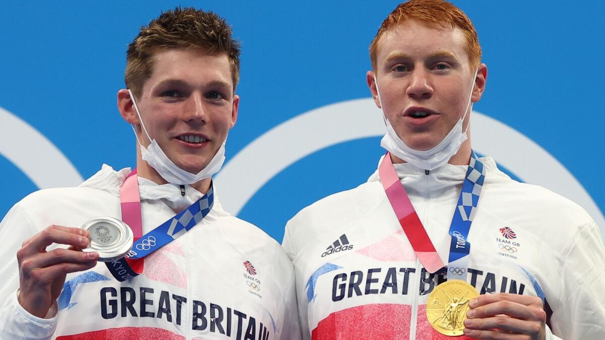 Tom Dean of Britain (right) and Duncan Scott of Britain pose with their gold and silver medal.