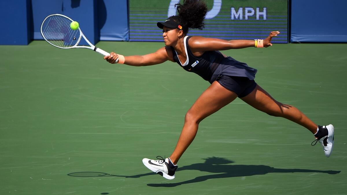 Naomi Osaka hits the ball against Elise Mertens during the Western &amp; Southern Open semifinal