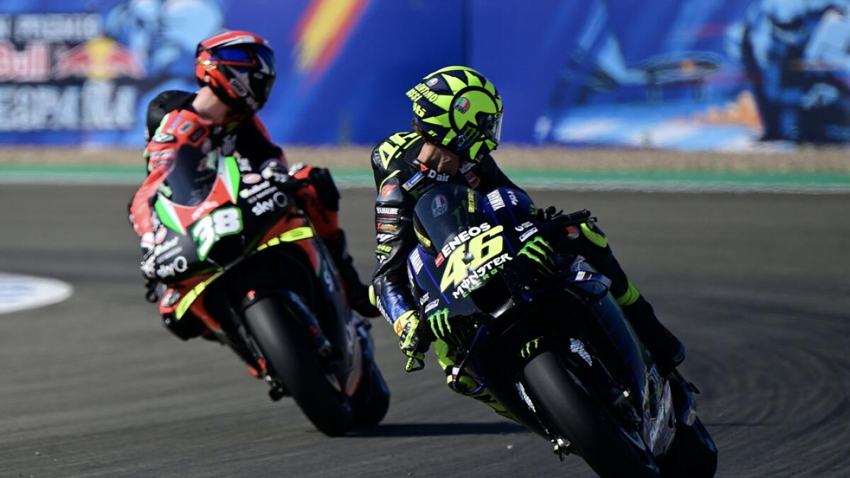 Monster Energy Yamaha's Italian rider Valentino Rossi (R) and Aprilia Factory Racing's British rider Bradley Smith look back during the third MotoGP free practice session of the Andalucia Grand Prix at the Jerez race track in Jerez de la Frontera. Photo:  AFP