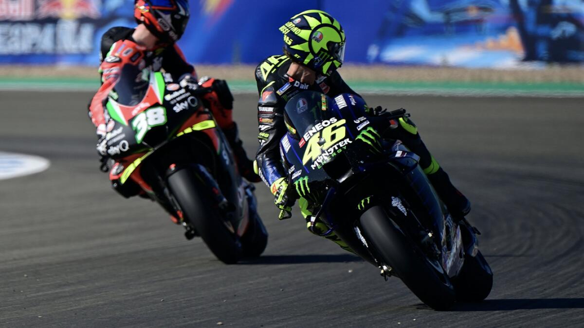 Monster Energy Yamaha's Italian rider Valentino Rossi (R) and Aprilia Factory Racing's British rider Bradley Smith look back during the third MotoGP free practice session of the Andalucia Grand Prix at the Jerez race track in Jerez de la Frontera. Photo:  AFP