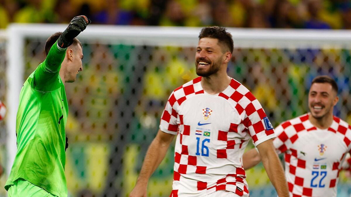 Croatia's Dominik Livakovic, Bruno Petkovic and Josip Stanisic celebrate qualifying for the semi finals. – Reuters