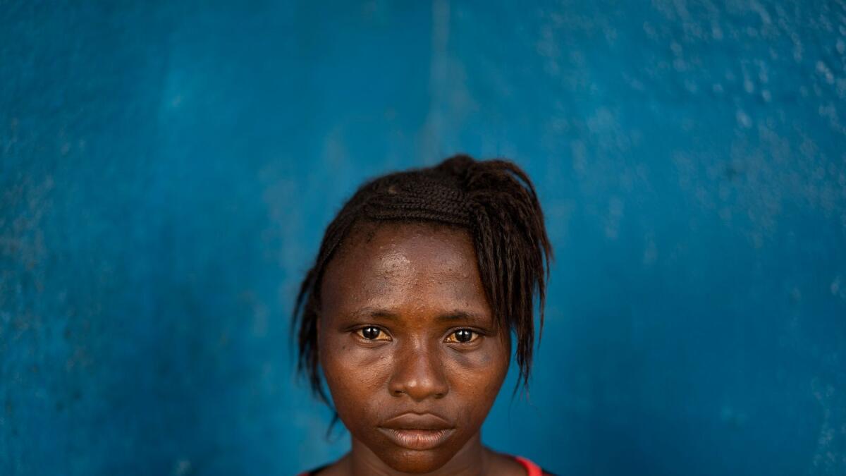 Kadiatu Mansaray poses for a picture in Lei Chiefdom, district of Kono, Sierra Leone, on Nov. 27, 2020. The 15-year-old teenager stopped going to school when she got pregnant three years ago and, at that time, the man she was having relation with didn’t recognise his paternity. This year, after being pressure by her mother, she married to another man who would take care of her and her daughter. “During the wedding ceremony I was not happy, I was crying with my head down”, says the young mother. Mansaray left her husband after suffering domestic violence. Today when she sees her friends coming out the school she cries. “I want to be with someone and learn something”, she completes.