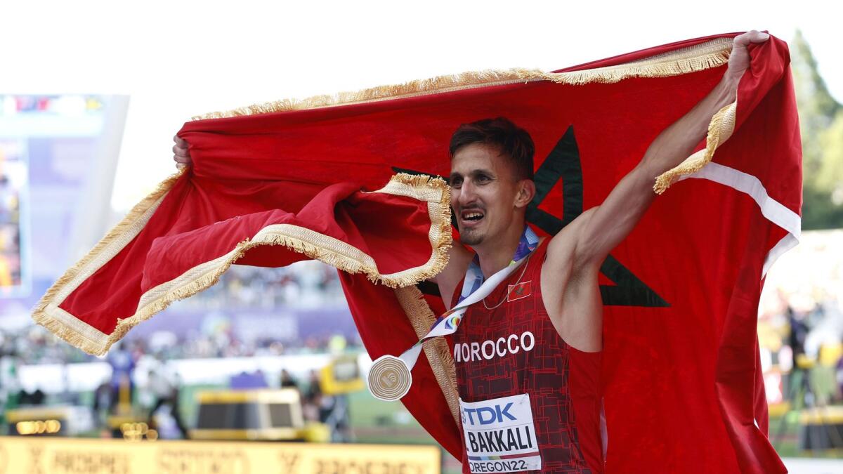 Soufiane El Bakkali of Morocco celebrates after winning gold in the men's 3000m steeplechase. (AFP)