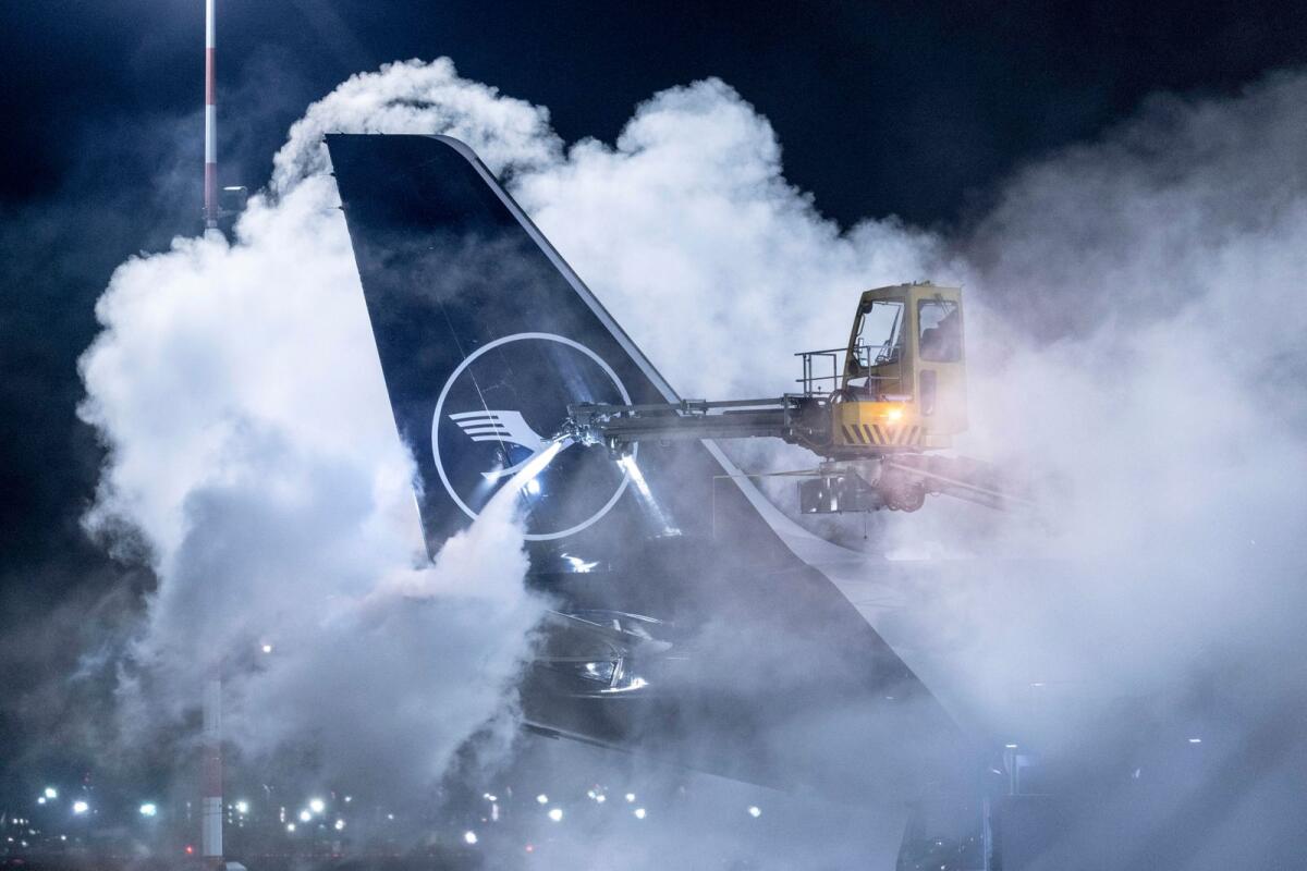 A Lufthansa aircraft is de-iced at Frankfurt Airport, Germany, on Wednesday.  — AP