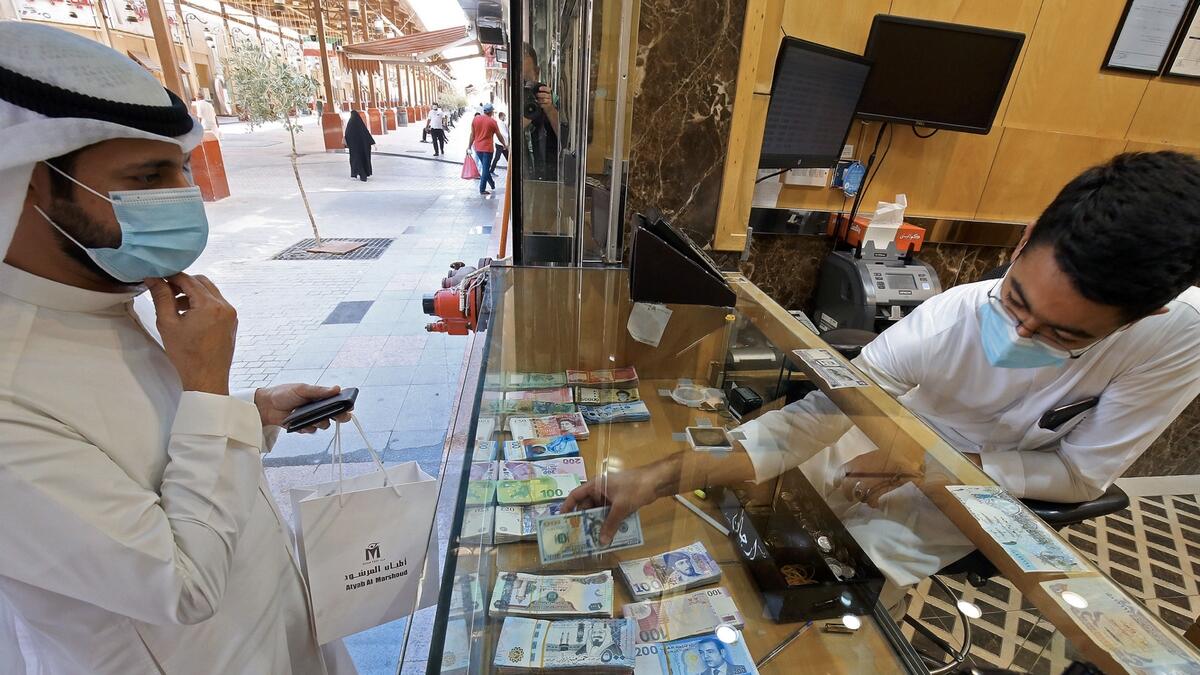 A Kuwaiti man stops at a currency exchange shop in Kuwait City, a sector heavily affected by the Covid-19 pandemic which caused a sharp drop in travel and tourism. Photo: AFP