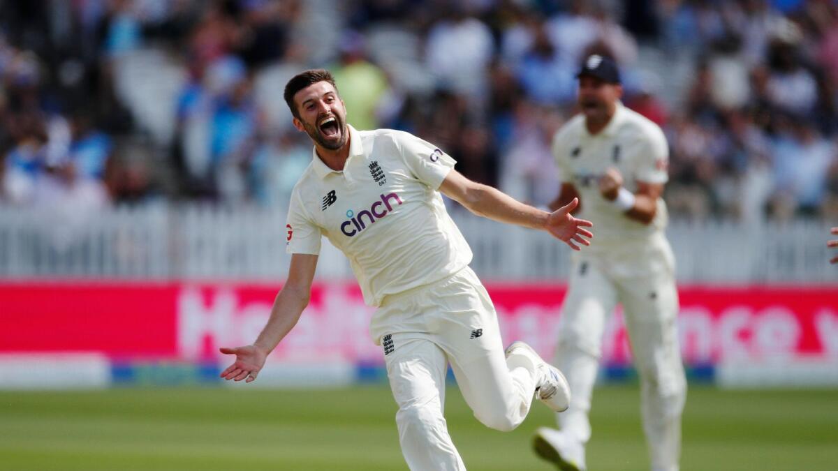 England's Mark Wood celebrates after taking the wicket of India's Rohit Sharma. — Reuters