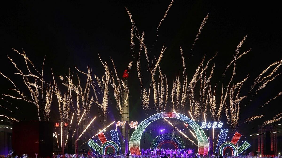 As the clock struck midnight in North Korea, a large crowd gathered for a concert in the centre of Pyongyang cheered as the clock struck midnight, with fireworks bursting in the sky above a neon-lit stage hosting a tightly-choreographed dance performance.