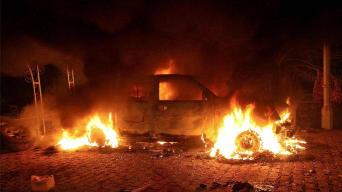 A vehicle and the surrounding area are engulfed in flames after it was set on fire inside the US consulate compound in Benghazi on September 11, 2012. — AFP file