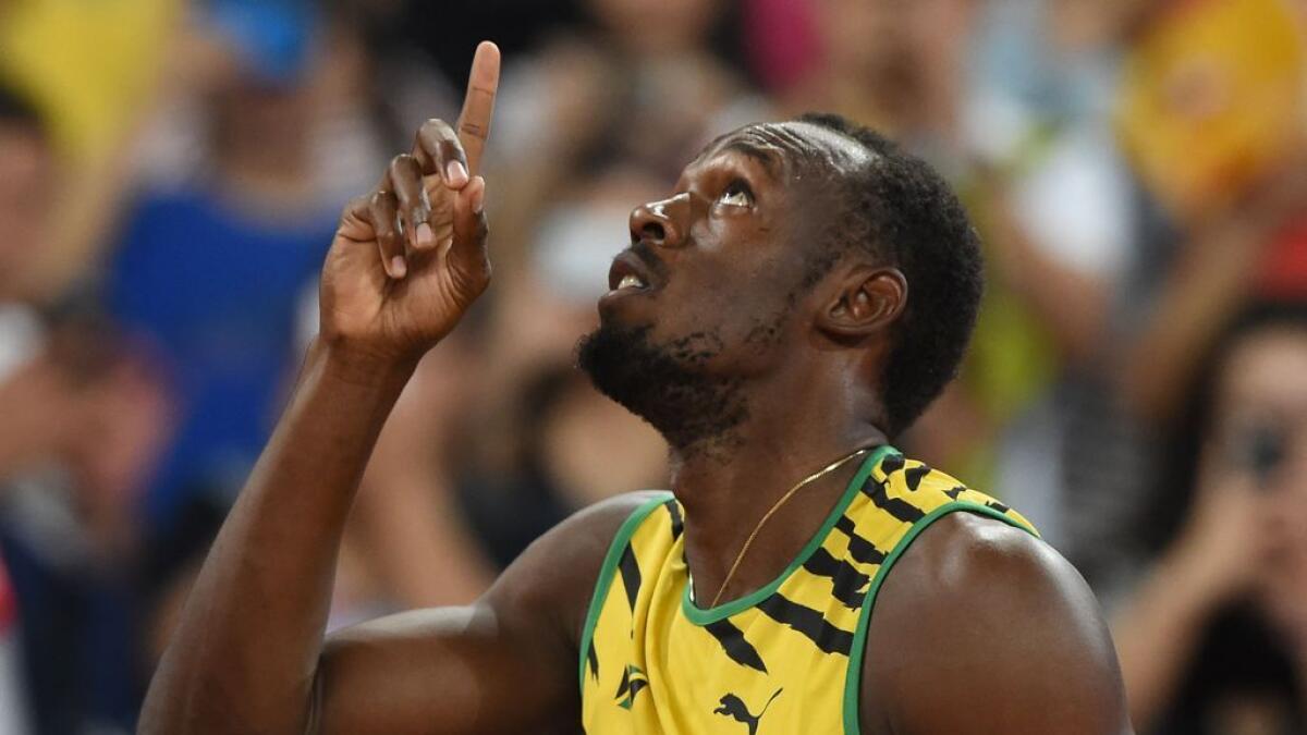 Jamaica's Usain Bolt reacts in the heats of the men's 100 metres athletics event at the 2015 IAAF World Championships at the 'Bird's Nest' National Stadium in Beijing on August 22, 2015.  