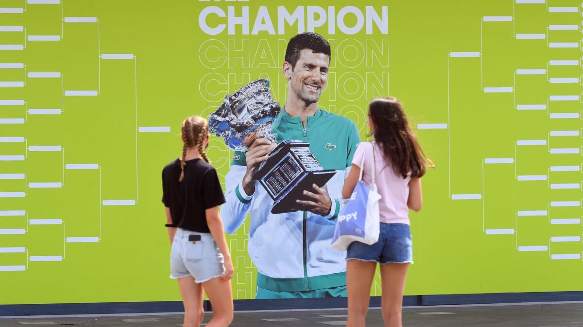 People look at an image of Novak Djokovic at the Melbourne Park tennis centre on Tuesday. (AFP)