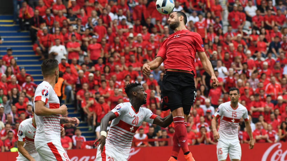 Albania's Mergim Mavraj heads the ball. (AP)