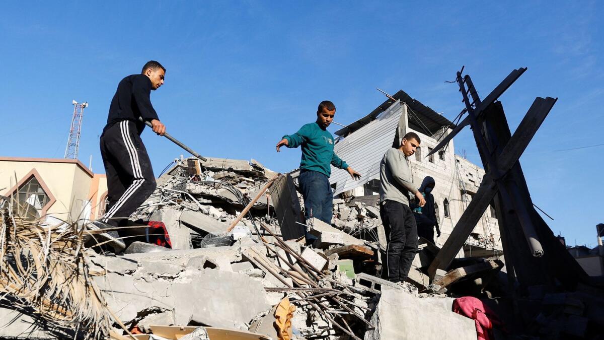 Palestinians inspect the damage at the site of Israeli strikes on houses in Khan Younis in the southern Gaza Strip. — Reuters