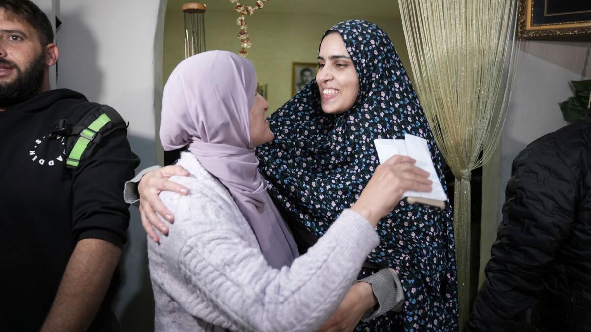 Marah Bakir, right, a former Palestinian prisoner who was released by the Israeli authorities, is welcome at her family house in the east Jerusalem neighborhood of Beit Hanina, Friday, Nov. 24, 2023. AP