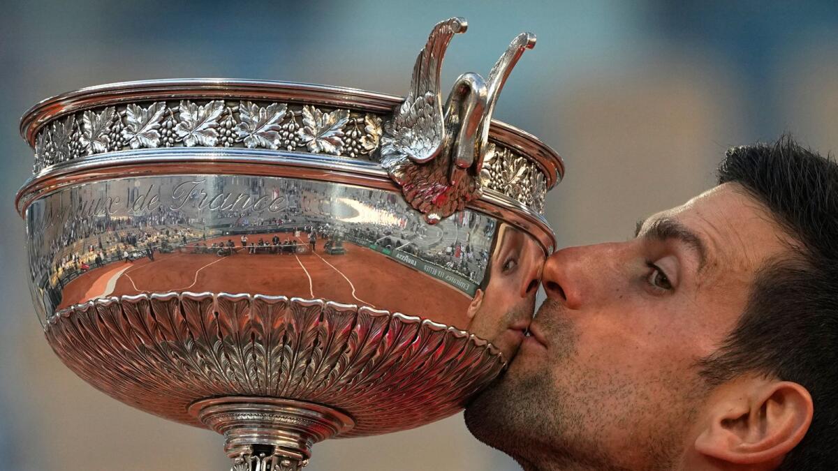 Serbia's Novak Djokovic kisses the cup after defeating Stefanos Tsitsipas of Greece after the French Open final. — AP