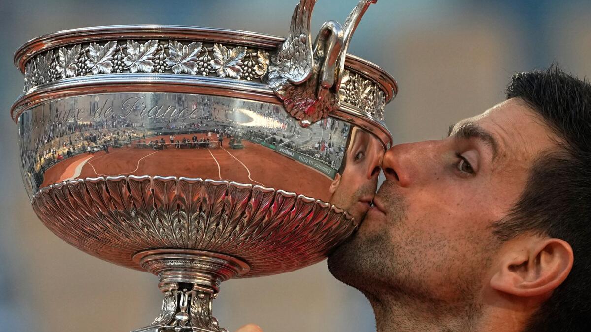 Serbia's Novak Djokovic kisses the cup after defeating Stefanos Tsitsipas of Greece after the French Open final. — AP