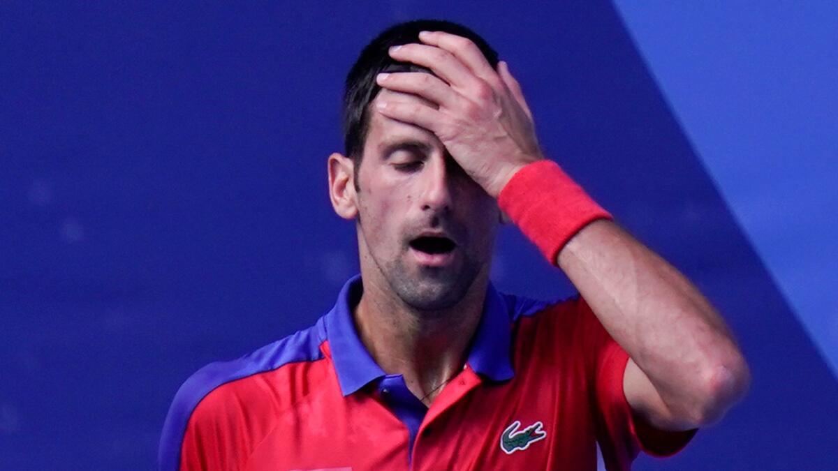 Novak Djokovic reacts during the bronze medal match of the tennis competition against Pablo Carreno Busta. — AP