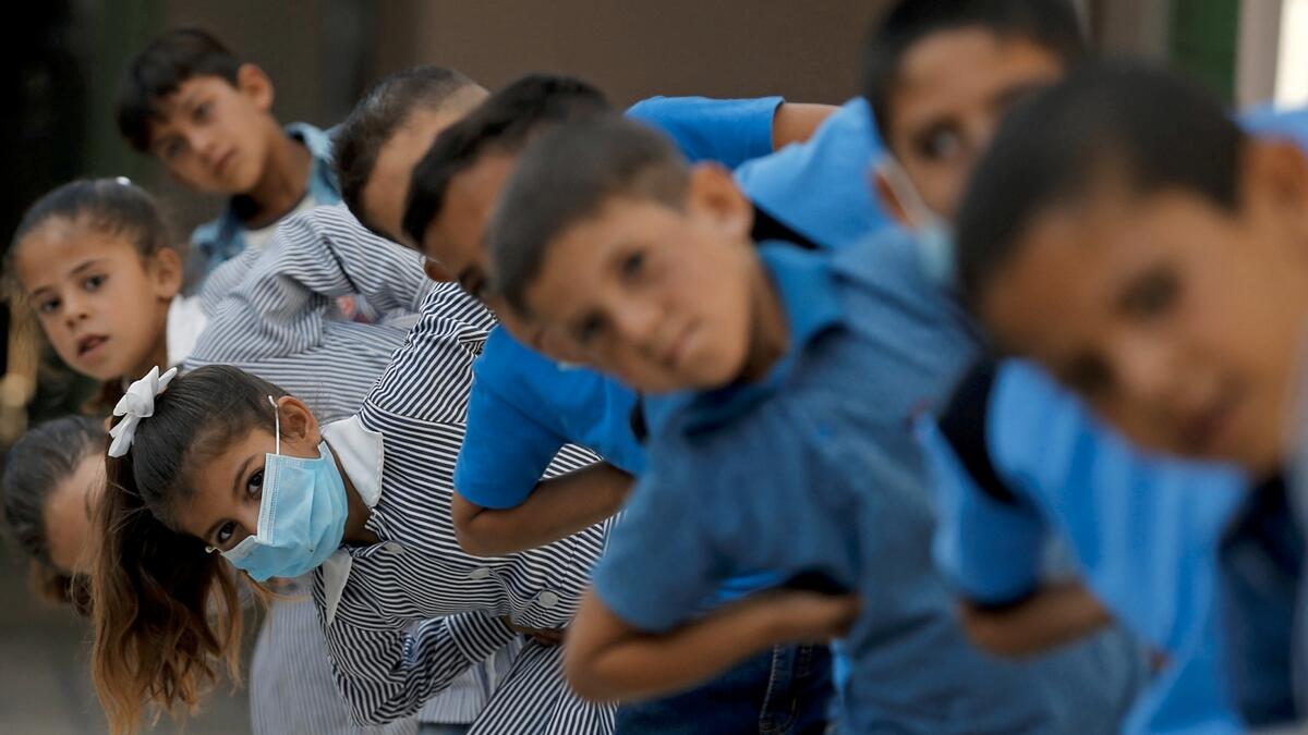 Palestinian students exercise at their school as schools reopen gradually amid the coronavirus disease (Covid-19) outbreak. Photo: Reuters